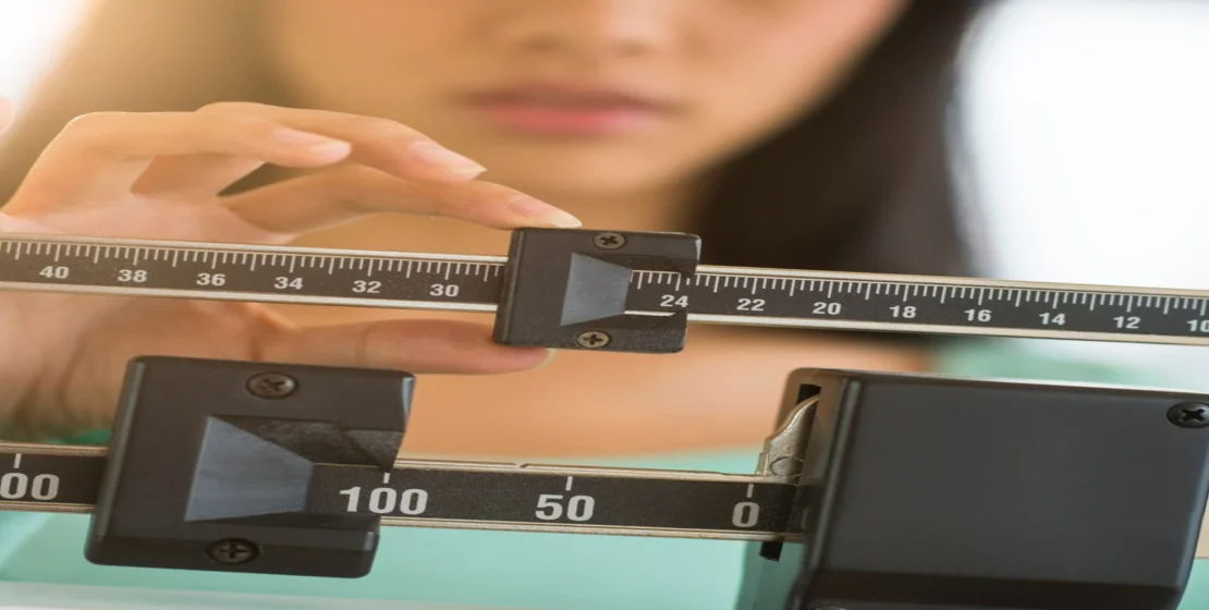 One Girl is with measuring scale for alcohol use disorder